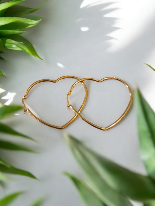 Heart-shaped earrings in gold-colored stainless steel.